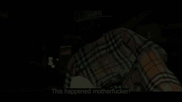a man in a plaid shirt is sitting in a car and says this happened motherfucker
