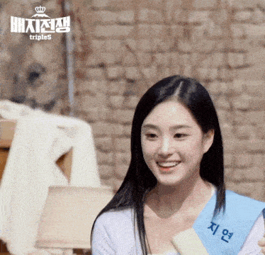 a woman is smiling and wearing a sash that says triples on it