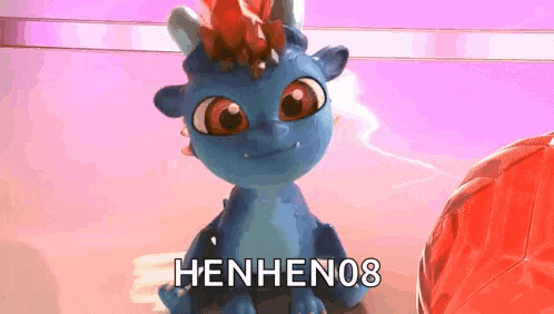 a blue toy dragon with a red crown on its head is sitting on a table .