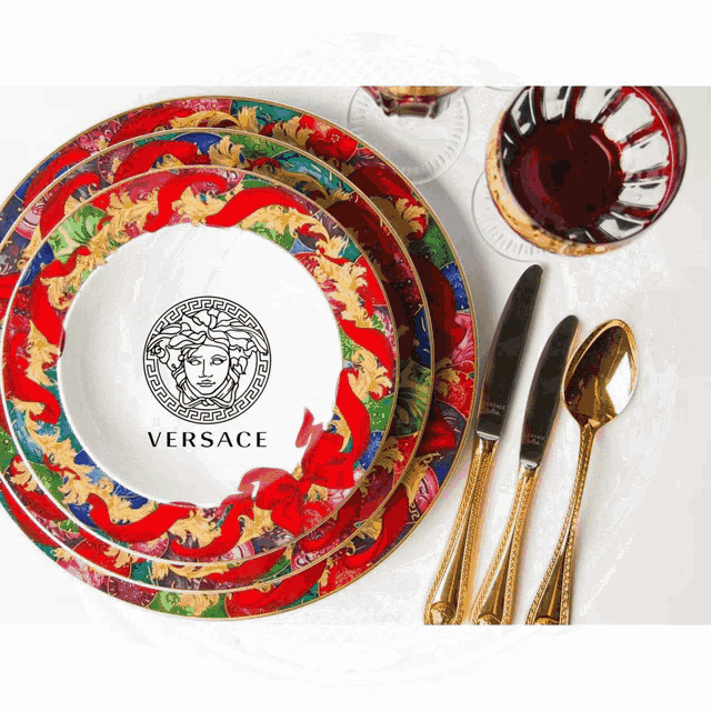 a stack of plates with versace on them