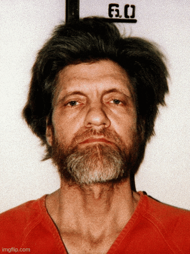 a man with a beard is wearing a red shirt and has the number 6.0 on his neck