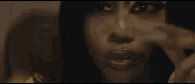 a close up of a woman 's face with a yellow eyeshadow on her eye .