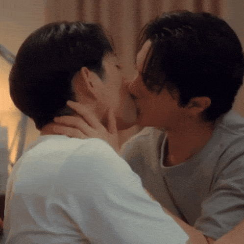 a couple of men kissing each other in a room