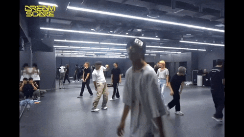 a group of people are dancing in a room with the word dream on the ceiling