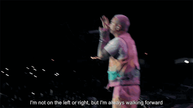 a man singing into a microphone with the words i 'm not on the left or right but i 'm always
