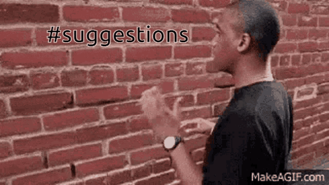 a man standing in front of a brick wall with the words suggestions written on it