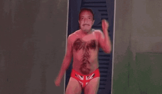a shirtless man in red underwear is standing in a locker room .