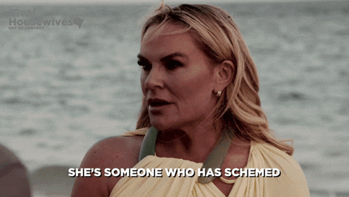 a woman says she 's someone who has schemed while standing on the beach