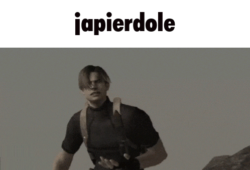 a man is kneeling down in front of a camera with the word japierdole above him