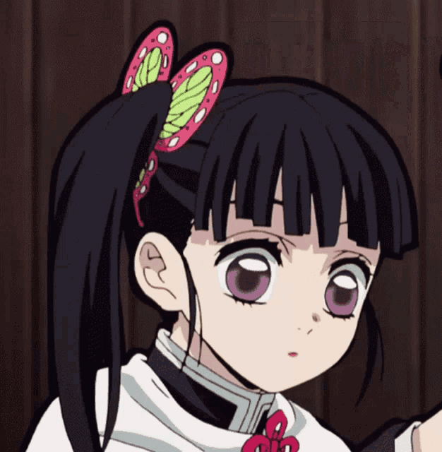 a girl with black hair and purple eyes is wearing a white shirt