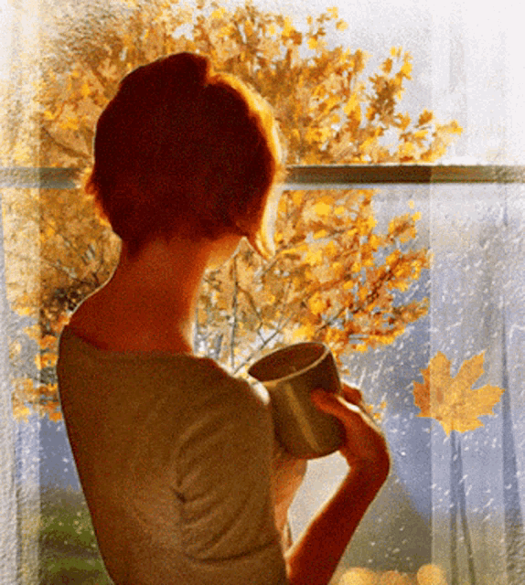 a woman holding a cup looking out a window