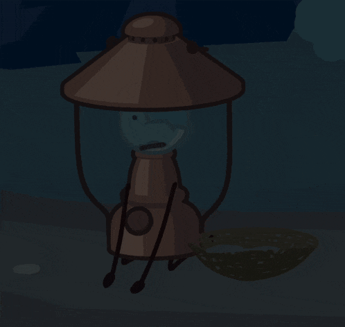 a lantern with arms and legs is sitting on the ground