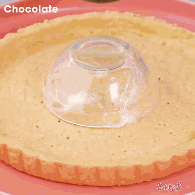 a chocolate sauce is being poured on top of a pie