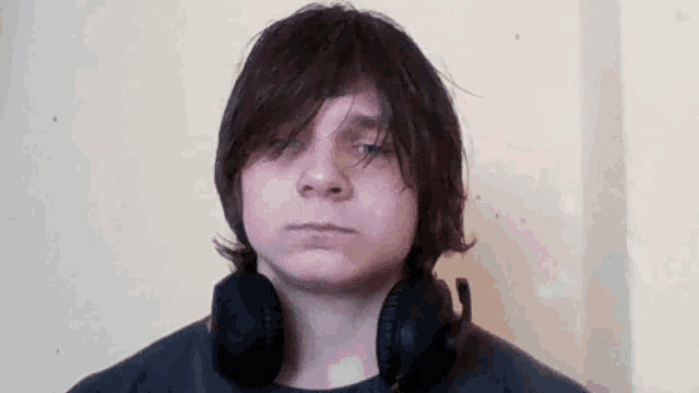 a young man wearing headphones and a black shirt