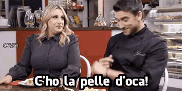 a man and a woman are sitting at a table and the woman says c'ho la pelle d' oca