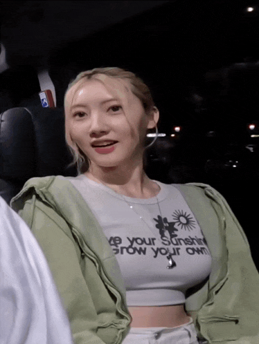a woman wearing a shirt that says " be your sunshine "