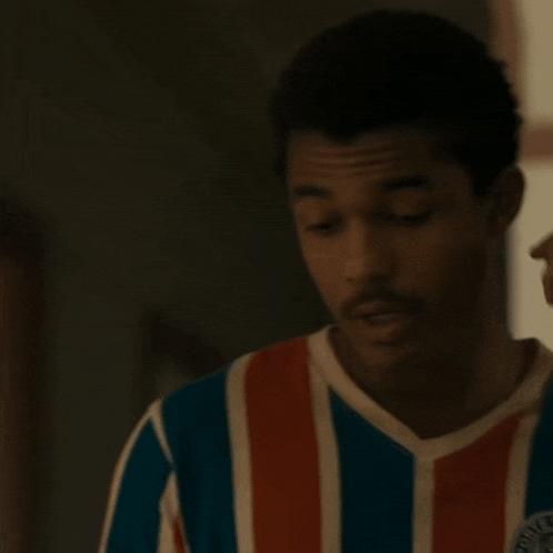 a man wearing a striped shirt that says ' bahia ' on the front