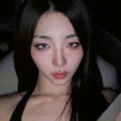 a close up of a woman 's face with a black background