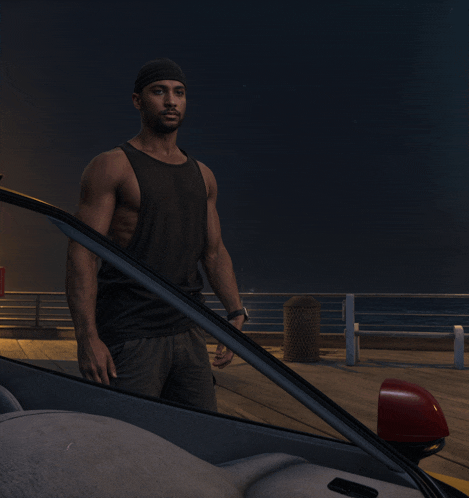 a man in a black tank top is standing next to a car on a pier