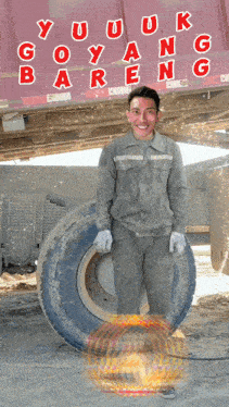 a man standing next to a tire with the words goyang bareng written on the back