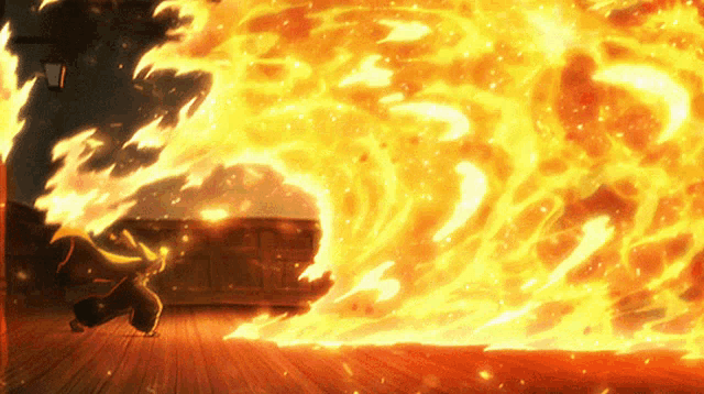 a person is standing in front of a large fire