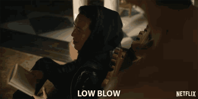a netflix ad shows a man in a hooded jacket sitting on the floor