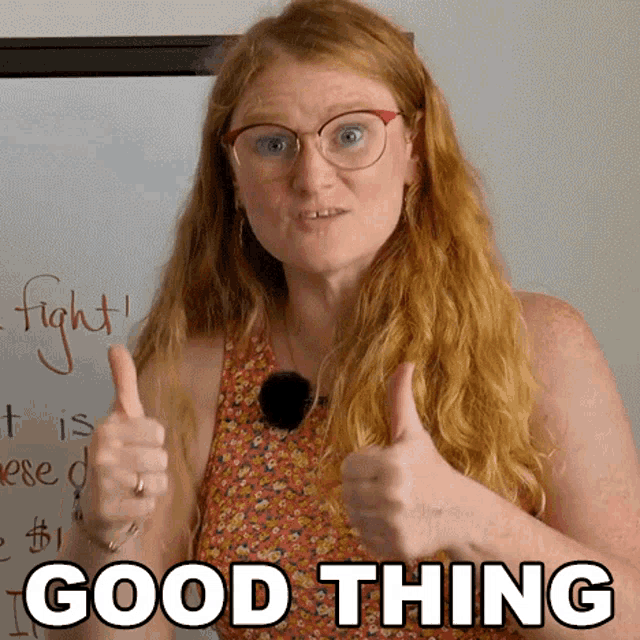 a woman wearing glasses gives a thumbs up with the words good thing behind her