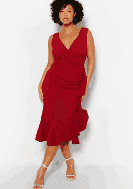 a plus size model is wearing a red dress with ruffles