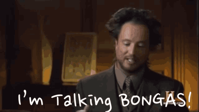 a man in a suit and tie is talking about bongas