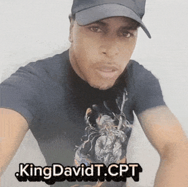 a man wearing a hat and a t-shirt that says kingdavidt.cpt