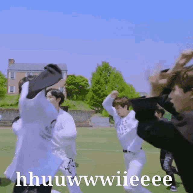 a group of young men are dancing on a field and one of them is wearing a shirt that says ' paris '
