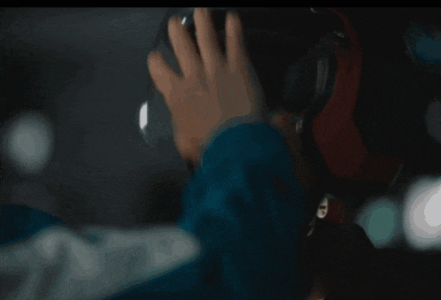 a person wearing headphones with the letter t on the bottom