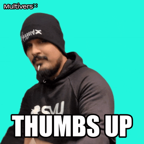 a man wearing a beanie and a hoodie with the words thumbs up on the bottom