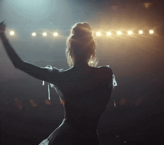 a silhouette of a woman with her arms in the air