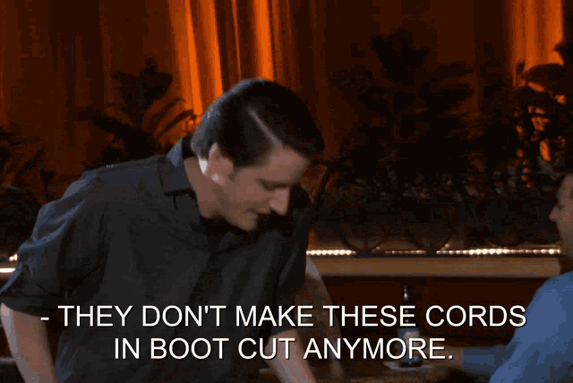 a man in a black shirt says they do n't make these cords in boot cut anymore on a screen