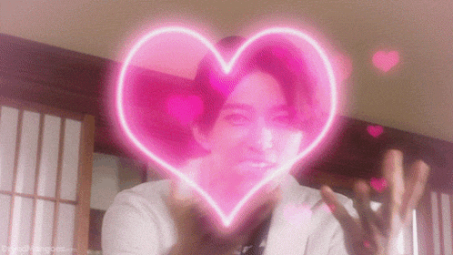 a man in a white shirt is surrounded by a pink heart .