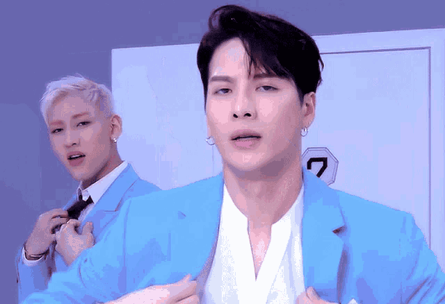 a man in a blue suit has a number 7 on his chest
