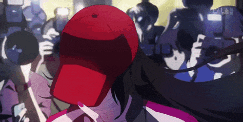 a woman wearing a red hat is surrounded by people