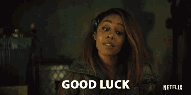 a woman is holding a glass with the words good luck written on it