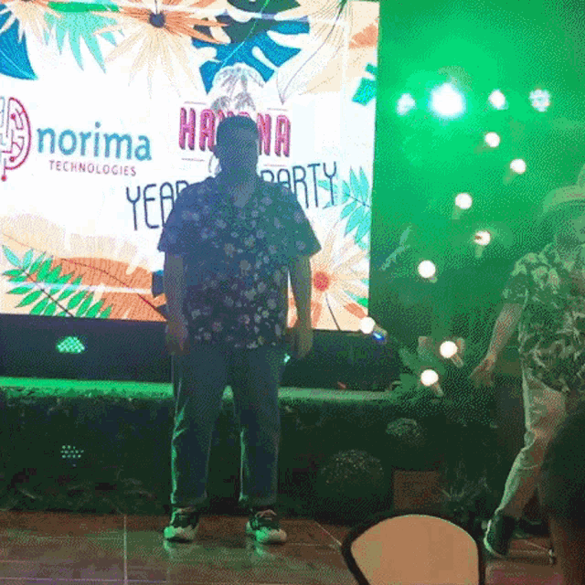 a man stands in front of a large screen that says norima technologies