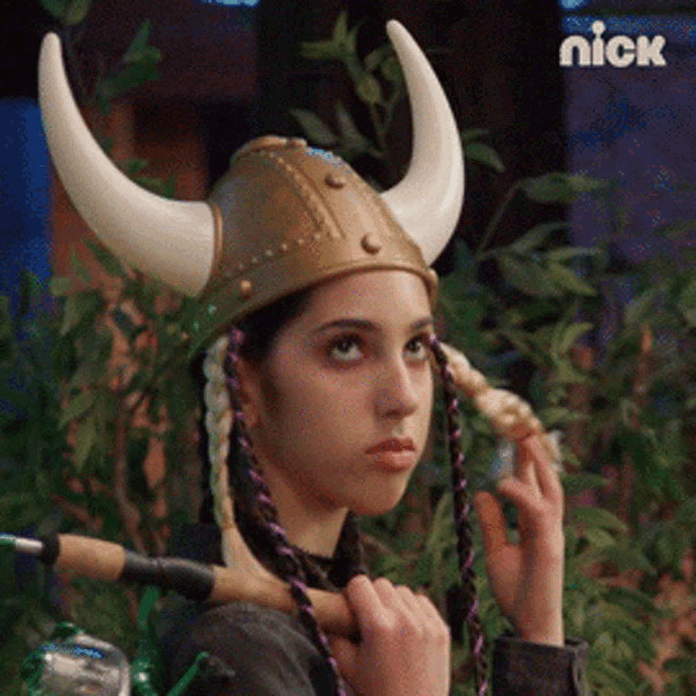 a girl wearing a viking helmet with horns