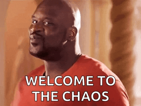 a man in a red shirt is saying welcome to the chaos .