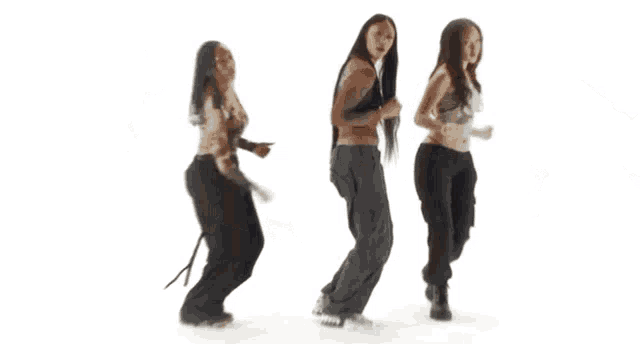 a group of people are standing in front of a white background .