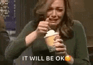 a woman is crying while holding an ice cream cone .