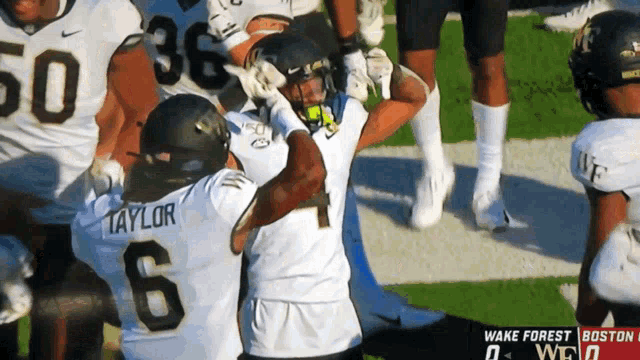 a football player named taylor is hugging another player on the field