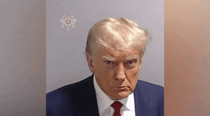 donald trump is wearing a suit and tie and has a fake haircut .