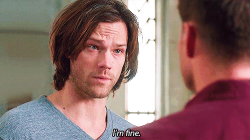 a man in a blue shirt says i 'm fine to another man in a red shirt