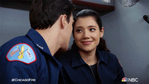 a man and a woman are looking at each other and the hashtag #chicagofire is on the bottom