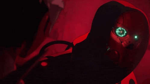 a red robot with green eyes and a hood