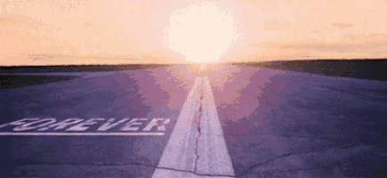 a runway with the word forever written on it at sunset